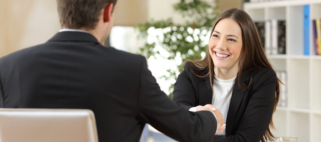 Woman Smiling and Shaking Hand with a man